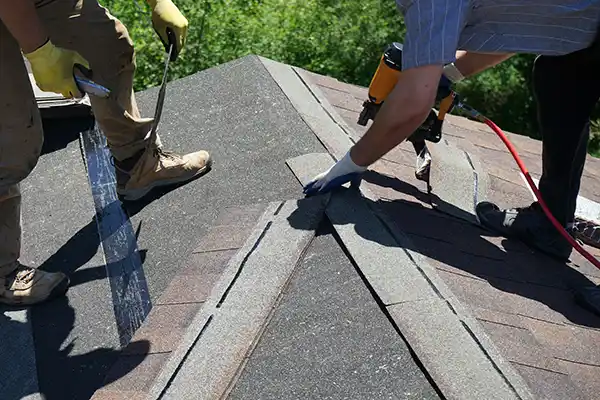 Roofers replacing shingles